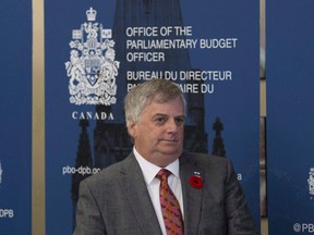 Parliamentary Budget Officer Jean-Denis Frechette is seen before speaking with the media, in Ottawa on November 1, 2016. A new analysis says roughly 900 Canadian families earning less than $100,000 per year will have to pay more taxes because of federal changes to tighten income-sharing rules for owners of small businesses. The federal budget watchdog says measures to restrict how much income the owners of private corporations can sprinkle to family members, as a way to save on taxes, will cost an average of $2,200 more per year for each of the 900 households earning less than $100,000 annually.