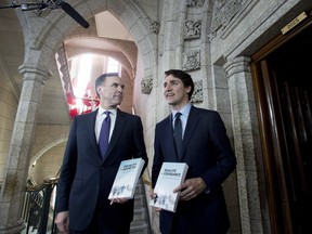 The 2018 federal budget includes $5.5 million over five years to develop a national framework aimed at addressing gender-based violence at universities and colleges countrywide, but the Liberals are dangling that carrot alongside a vaguely defined stick. Minister of Finance Bill Morneau walks with Prime Minister Justin Trudeau before tabling the budget in the House of Commons on Parliament Hill in Ottawa on Tuesday, Feb. 27, 2018.