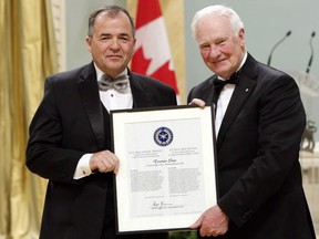 Toronto Star editor Michael Cooke is presented by Governor General David Johnston, with a Michener Award citation of merit for public service in journalism during a ceremony at Rideau Hall in Ottawa, Friday, June 17, 2016. The Toronto Star newspaper says Cooke will step down on June 1 after more than nine years in the job.