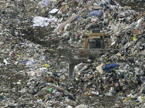 Garbage is moved at a landfill in Sumpter Township, Mich., Monday, March 3, 2003. A massive report by the three countries in the North American Free Trade Agreement says the amount of waste Canadians generate continues to increase.