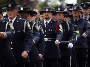 Alberta peace officers march in a regimental memorial parade to honour peace officer Rod Lazenby in High River, Alta., Friday, Aug. 24, 2012. Lazenby, a former Mountie, was killed in the line of duty on Friday, August 10, 2012 near Priddis, Alta. An Alberta judge is recommending changes to how peace officers deal with mentally unstable people after the death of an officer in 2012.