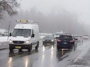 Cars drive through the fog on Calmillien-Houde Way through Mount Royal park Tuesday, February 20, 2018 in Montreal. Montreal's new government is backing off a plan to immediately limit car access to the city's iconic Mount Royal Park after thousands of citizens signed a petition criticizing the move.