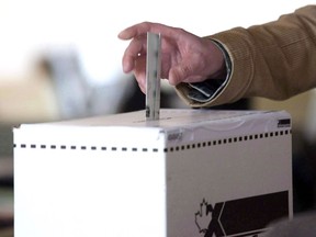 A voter casts a ballot in the 2011 federal election in Toronto on May 2, 2011.