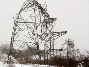 Several power transmission towers are toppled by heavy, wet snow, coupled with high winds in Dartmouth, N.S. on Sunday, Nov. 14, 2004. The increasing intensity of storms that lead to massive power outages highlights the need for Canada's electrical utilities to be more robust and innovative, climate change scientists say.