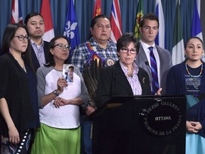 Senator Kim Pate stands with advocates and family members of Colten Boushie, rear left to right, Eleanore Sunchild, Sheldon Wuttunee, Debbie Baptiste, mother of Colten Boushie, Alvin Baptiste, uncle of Colten Boushie, Senator Kim Pate, lawyer Chris Murphy, and Jade Tootoosis, cousin of Colten Boushie, as she speaks during a press conference on Parliament Hill in Ottawa on February 14, 2018.