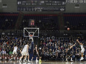 Connecticut's Megan Walker (3), right, hits a 3-point basket with one minute left in the first half of play to bring UConn to 90 points against Saint Francis (Pa.) during a first-round game in the NCAA women's college basketball tournament in in Storrs, Conn., Saturday, March 17, 2018. UConn has set the NCAA all-time record for points in a half with 94.
