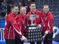 Team Canada skip Brad Gushue, third Mark Nichols, second Brett Gallant and lead Geoff Walker, left to right, pose with the Brier Tankard after defeating Alberta 6-4 to win the 2018 Canadian championship in Regina on Sunday, March 11, 2018.