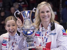Canada third Kaitlyn Lawes, left, hotobombs skip Jennifer Jones after they won the gold medal over Sweden at the women's world curling championship in North Bay, Ont., on , Sunday, March 25, 2018.