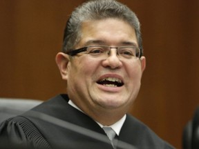 FILE - In this Nov. 25, 2013 file photo, Chief U.S. District Judge Ruben Castillo speaks from the bench in Chicago. Castillo is slated to issue a first-in-the-nation ruling Monday, March 12, 2018, about whether law enforcement stings where suspects are talked into robbing non-existent drugs from non-existent stash houses are racially biased.