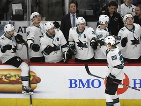 San Jose Sharks' Marcus Sorensen (20) of Sweden, celebrates with teammates on the bench after scoring a goal during the first period of an NHL hockey game against the Chicago Blackhawks Monday, March 26, 2018, in Chicago.