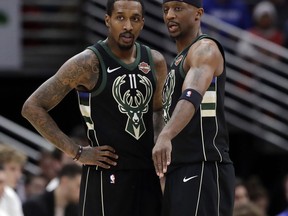 Milwaukee Bucks guard Brandon Jennings, left, listens to guard Jason Terry during the first half of the team's NBA basketball game against the Chicago Bulls, Friday, March 23, 2018, in Chicago.
