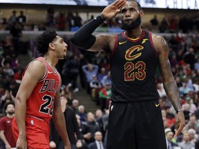 Cleveland Cavaliers forward LeBron James, right, reacts after blocking a shot by Chicago Bulls guard Cameron Payne during the second half of an NBA basketball game Saturday, March 17, 2018, in Chicago. The Cavaliers won114-109.