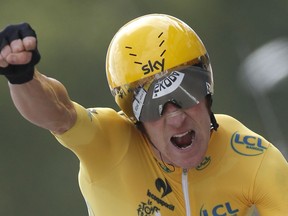 In this July 21, 2012 file photo, Bradley Wiggins celebrates as he crosses the finish line of the 19th stage of the the Tour de France in Chartres, France.