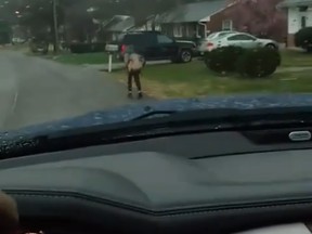 Bryan Thornhill's son runs ahead of his vehicle in this still image from a video posted to Facebook.