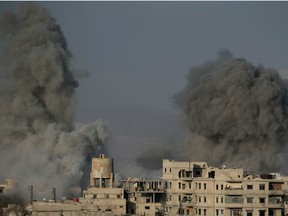 Smoke billows following Syrian government bombardments on the besieged rebel-held town of Hamouria in the eastern Ghouta region on the outskirts of the capital Damascus on March 3, 2018. Government forces intensified fighting inside Syria's Eastern Ghouta, as tens of thousands of civilians in the besieged rebel enclave east of Damascus awaited urgently needed aid.