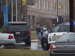 Two students and a mother leave Great Mills High School, the scene of a shooting, Tuesday morning, March 20, 2018 in Great Mills, Md. The shooting left at least three people injured including the shooter.