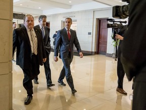 President Donald Trump's former campaign manager Cory Lewandowski, center, and his lawyer Peter Chavkin, second from left, arrive to meet behind closed doors with the House Intelligence Committee, at the Capitol in Washington, Thursday, March 8, 2018.