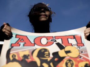 A student from Marjory Stoneman Douglas High School holds a sign during the "March for Our Lives" rally in support of gun control in Washington, Saturday, March 24, 2018.