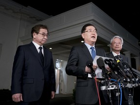 South Korean national security director Chung Eui-yong, center, speaks to reporters at the White House in Washington, Thursday, March 8, 2018, as intelligence chief Suh Hoon, left and Cho Yoon-je, the South Korea ambassador to United States, listen. President Donald Trump has accepted an offer of a summit from the North Korean leader and will meet with Kim Jong Un by May, a top South Korean official said in a remarkable turnaround in relations between two historic adversaries.