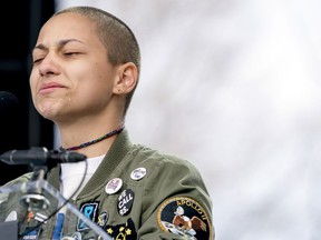 Emma Gonzalez, a survivor of the mass shooting at Marjory Stoneman Douglas High School in Parkland, Fla., closes her eyes and cries as she stands silently at the podium and times the amount of time it took the Parkland shooter to go on his killing spree during the "March for Our Lives" rally in support of gun control in Washington, Saturday, March 24, 2018.