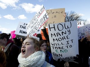 Students hold up their signs during a rally asking for gun control outside of the U.S. Capitol building, in Wednesday, March 14, 2018, in Washington. One month after a mass shooting in Florida, students and advocates across the country participate in walkouts and protests to call on Congress for action.