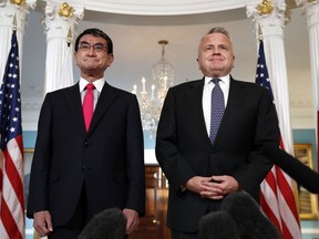Japanese Foreign Minister Taro Kono, left, meets with Deputy Secretary of State John Sullivan, Friday, March 16, 2018, at the State Department in Washington.