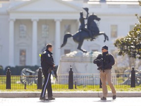 Law enforcement officers at Lafayette Park across from the White House in Washington, close the area to pedestrian traffic, Saturday, March 3, 2018. A man apparently shot himself along the north fence of the White House midday, according to the Secret Service, which also said he was being treated for the wound.
