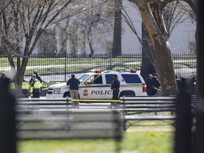 Law enforcement officers gather infront of the White House in Washington, Saturday, March 3, 2018.    The Secret Service says a man shot himself outside the White House, and medical personnel are on the scene. President Donald Trump is not at the White House,  he's in Florida, but is set to return later Saturday. The agency says in a Twitter post that there are no other reported injuries related to the incident.