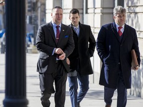 Former Trump campaign aide Sam Nunberg, left, arrives at the U.S. District Courthouse to appear before a grand jury, Friday, March 9, 2018 in Washington.  Nunberg had insisted in a series of defiant interviews earlier in the week that he intended to defy a subpoena issued by special counsel Robert Mueller's office, which is investigating potential coordination between Russia and the Trump campaign.