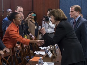 From left, Kimberly Bose, of Alexandria, Va., whose son Joseph Bose was killed by gun violence in 2015, Hank Stawinski, police chief of the Prince George's County Police Department in suburban Washington, is greeted by Sen. Dianne Feinstein, D-Calif., and Sen. Richard Blumenthal, D-Conn., during an event sponsored by Senate Democrats on protecting children from gun violence, at the Capitol in Washington, Wednesday, March 7, 2018.