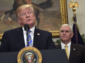 Vice President Mike Pence, right, listens as President Donald Trump speaks in the Roosevelt Room at the White House in Washington, Thursday, March 8, 2018, during an event where Trump signed two proclamations, one on steel imports and the other on aluminum imports.