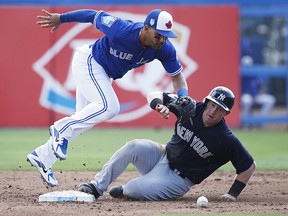 Billy McKinney of the New York Yankees slides safely into second base after the ball was dropped by Devon Travis of the Toronto Blue Jays at Florida Auto Exchange Stadium on February 27, 2018 in Dunedin, Florida. (Joe Robbins/Getty Images)