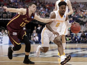 Loyola-Chicago guard Clayton Custer (13) gives chase as Tennessee guard Jordan Bone (0) works toward the basket during the first half of a second-round game at the NCAA men's college basketball tournament in Dallas, Saturday, March 17, 2018.