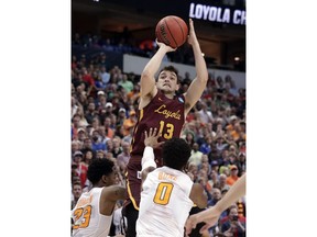 Loyola-Chicago guard Clayton Custer (13) shoots over Tennessee's Jordan Bowden (23) and Jordan Bone (0), sinking the shot in the final seconds of a second-round game at the NCAA men's college basketball tournament in Dallas, Saturday, March 17, 2018. The shot helped Loyola to a 63-62 win.