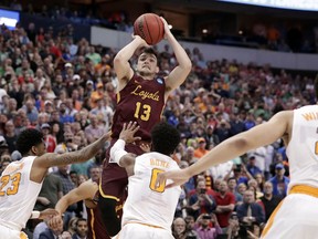 Loyola-Chicago guard Clayton Custer (13) shoots over Tennessee's Jordan Bowden (23) and Jordan Bone (0) and scores in the final seconds of a second-round game at the NCAA men's college basketball tournament in Dallas, Saturday, March 17, 2018. The shot helped Loyola to a 63-62 win.