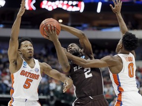 St. Bonaventure guard Matt Mobley (2) battles Florida guards KeVaughn Allen (5) and Mike Okauru (0) during the first half of a first-round game at the NCAA college basketball tournament in Dallas, Thursday, March 15, 2018.