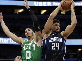 Orlando Magic's Khem Birch (24) grabs a rebound away from Boston Celtics' Jayson Tatum (0) during the first half of an NBA basketball game Friday, March 16, 2018, in Orlando, Fla.