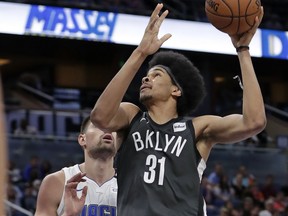 Brooklyn Nets' Jarrett Allen (31) makes a shot in front of Orlando Magic's Nikola Vucevic (9) during the second half of an NBA basketball game, Wednesday, March 28, 2018, in Orlando, Fla.