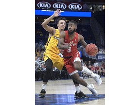 Houston guard Corey Davis Jr. (5) drives to the basket in front of Wichita State guard Landry Shamet (11) during the first half of an NCAA college basketball game in the semifinals at the American Athletic Conference tournament Saturday, March 10, 2018, in Orlando, Fla.