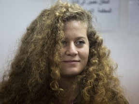 FILE - In this Feb. 13, 2018 file photo, Palestinian protest icon Ahed Tamimi is in a courtroom at the Ofer military prison near Jerusalem. Bassem Tamimi, Ahed's father, said Tuesday, March 20, 2018, he has visited his daughter and wife in jail for the first time since they were both arrested in December.