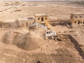 This Tuesday, March 27, 2018 photo released by HALO Trust shows a digger working at de-mining the land near the baptismal site of Jesus Christ, Qasr al Yahud, in the West Bank. Pilgrims seeking serenity during a visit to Jesus' traditional baptism site may be rattled by what greets them: thousands of land mines left over from dormant Mideast conflicts. But a new project is working to rid the West Bank site of the explosive devices, clearing away the relics of war that have blemished the sacred place for nearly five decades. (HALO Trust via AP)