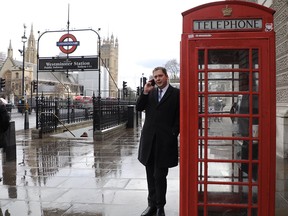 Conservative leader Andrew Scheer leans on a telephone booth in London on March 6, 2018.