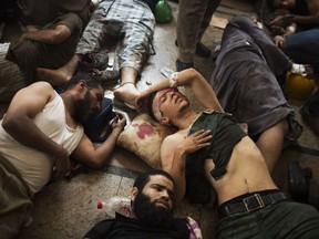 FILE - In this Aug. 14, 2013 file photo, wounded supporters of ousted Islamist President Mohammed Morsi lie on the floor of a makeshift hospital at a sit-in in Cairo, Egypt. On Aug. 14, 2013, more than 600 people, mostly Morsi supporters, were killed when police cleared two pro-Morsi sit-ins in Cairo. Sept. 23, 2013, an Egyptian court orders the Brotherhood banned and its assets confiscated. On March 26-28, 2018, a Presidential election will be held in Egypt, with President Abdel-Fattah el-Sissi virtually guaranteed to win.