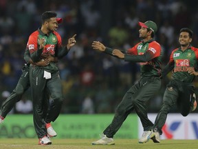 Bangladesh's Shakib Al Hasan, left, celebrates the the dismissal of Sri Lanka's Danushka Gunathilaka with his team mates during their second Twenty20 cricket match in Nidahas triangular series in Colombo, Sri Lanka, Friday, March 16, 2018.