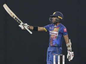 Sri Lankas' Kusal Mendis celebrates scoring a half century against India during their Twenty20 cricket match in Nidahas triangular series in Colombo, Sri Lanka, Monday, March 12, 2018.