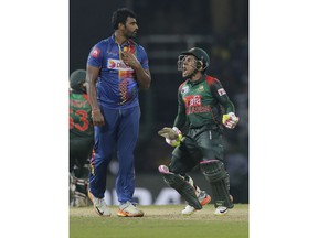 Bangladeshes' Mushfiqur Rahim, right, celebrates his steam's victory over Sri Lanka as Thisara Perera watches in their Twenty20 cricket match in Nidahas triangular series in Colombo, Sri Lanka, Saturday, March 10, 2018.