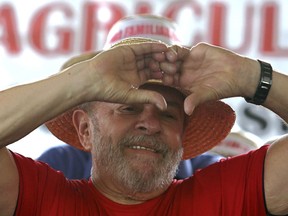 Brazil's former President Luiz Inacio Lula da Silva makes a heart shape as he meets with supporters for a rally on a farm in Nova Erechim in southern Brazil, Sunday, March 25, 2018. The former leader is leading polls for October's presidential election, but is likely to be barred from running and judges could order him early as Monday to begin serving his sentence on a corruption conviction.