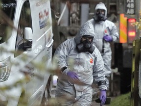 Military forces work on a van in Winterslow, England, Monday, March 12, 2018, as investigations continue into the nerve-agent poisoning of Russian ex-spy Sergei Skripal and his daughter Yulia, in Salisbury, England, on Sunday March 4, 2018. British Prime Minister Theresa May is set to update lawmakers Monday on the nerve-agent poisoning of ex-spy Sergei Skripal and his daughter.