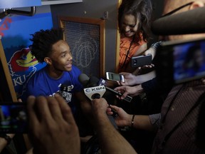 Kansas's Devonte' Graham answers questions after a practice session for the Final Four NCAA college basketball tournament, Thursday, March 29, 2018, in San Antonio.
