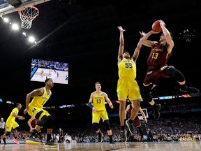 Loyola-Chicago guard Clayton Custer (13) shoots over Michigan guard Eli Brooks (55) during the first half in the semifinals of the Final Four NCAA college basketball tournament, Saturday, March 31, 2018, in San Antonio.